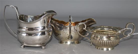 A George III silver cream jug, a silver and gilt two-handled sauce boat and a small silver two-handled fluted bowl with cast rim